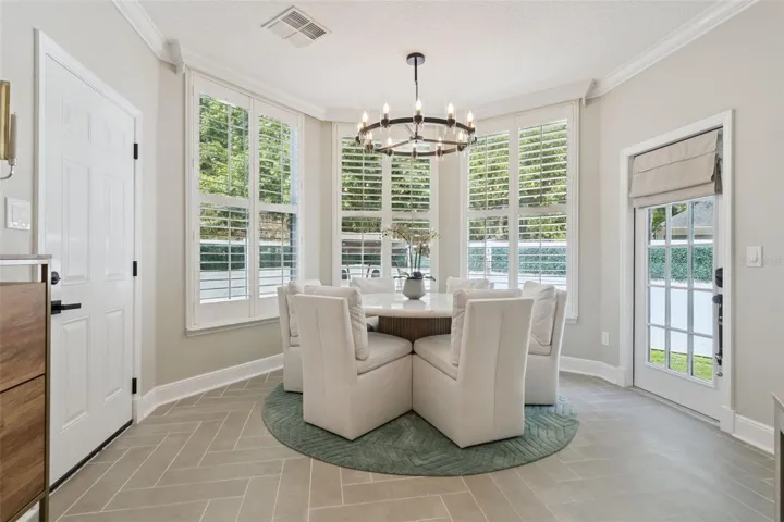 Dining area overlooking private yard and conservation space.