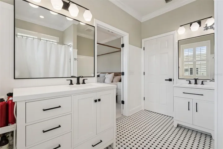 Updated primary bathroom with complimentary vanities.