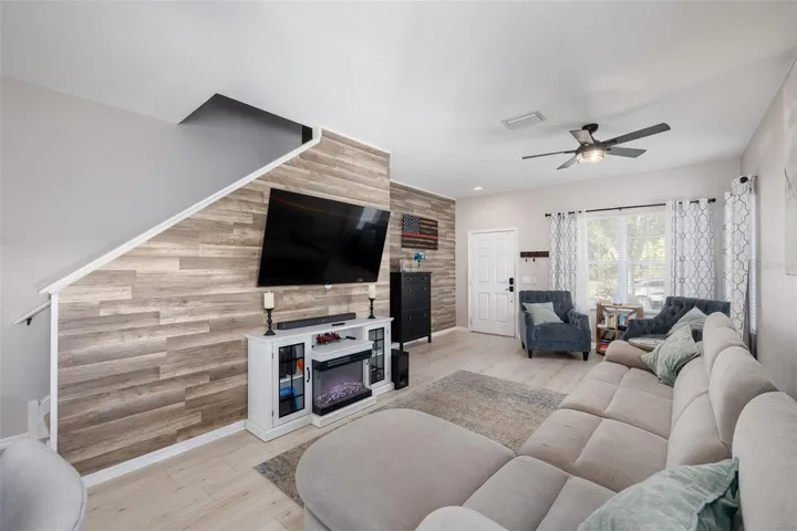 Downstairs Spacious Living Room with Beautiful Waterproof Laminate Flooring and Accent Wall!