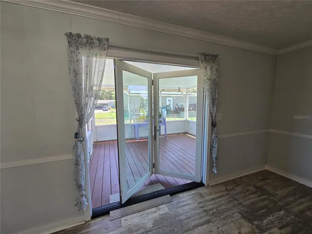 Accessible feature: easy glide fully opening sliding door to screen enclosed, covered porch.