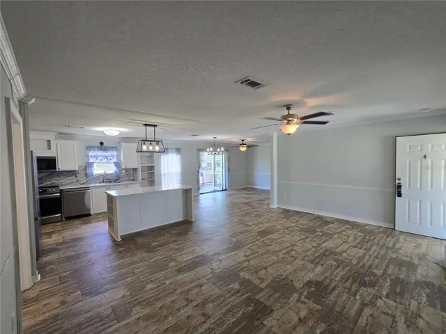 Great room. Open floorplan. Crown molding. Updated lighting, ceiling fans.