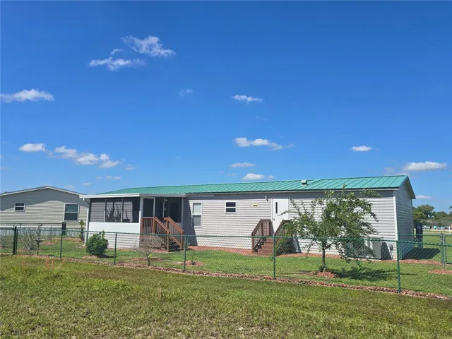 Metal roof, fenced backyard, fruit trees