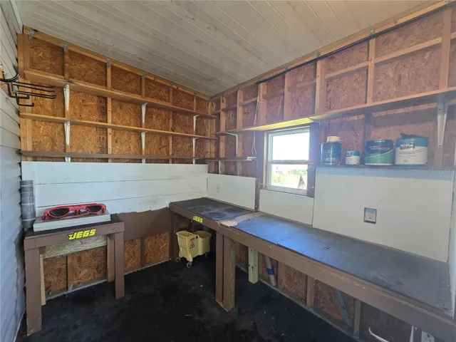 80 sq. ft workshop, shelving & workbenches.