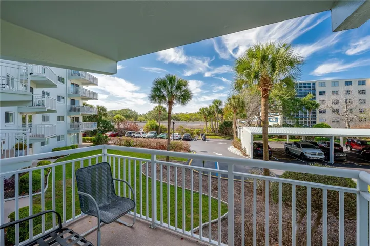Private covered balcony overlooking the community, offering a peaceful spot to enjoy fresh air and morning coffee.
