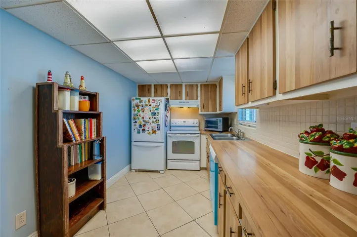 Functional kitchen with wood cabinetry, ample counter space, and a practical layout ideal for everyday meal prep.