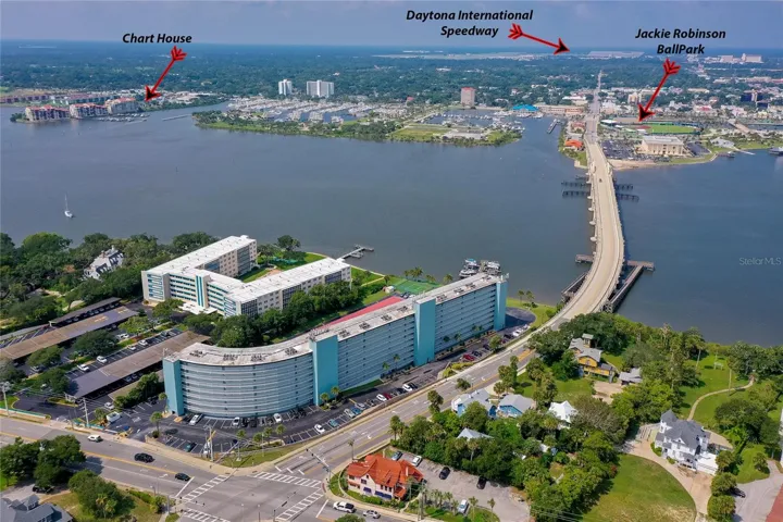 Expansive view of the surrounding area, showcasing nearby waterways, residential neighborhoods, and coastal access.