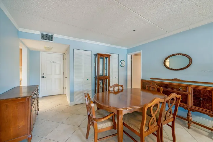 Another perspective highlighting the layout, tile flooring, and convenient proximity to the kitchen and entry.