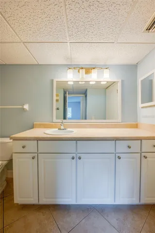 Wide vanity with abundant cabinet storage and a large mirror, providing both style and functionality.