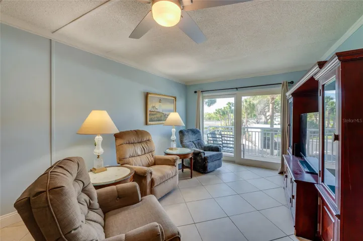 Comfortable living area with large sliding glass doors that fill the space with natural light and provide access to the private balcony.
