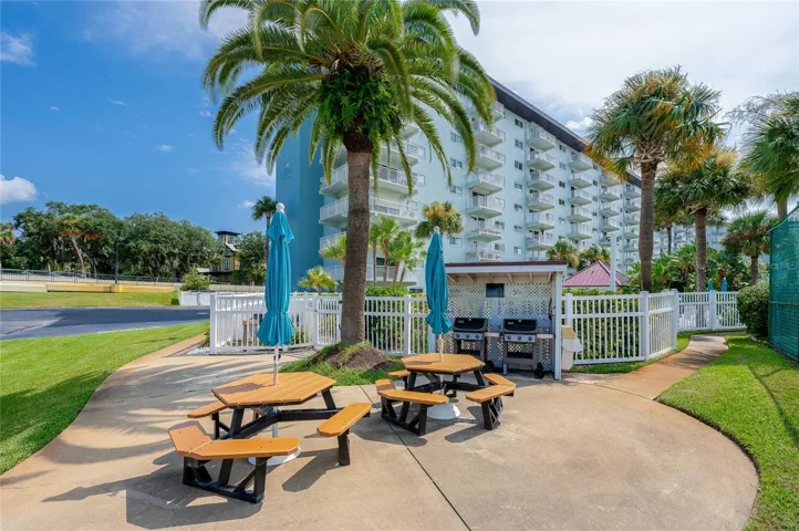 Community grilling and picnic area with seating, ideal for outdoor dining and social gatherings.