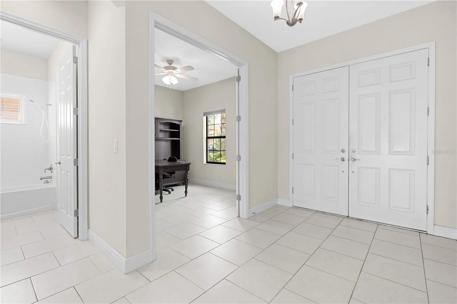 front door entry with view of office and downstairs guest bathroom