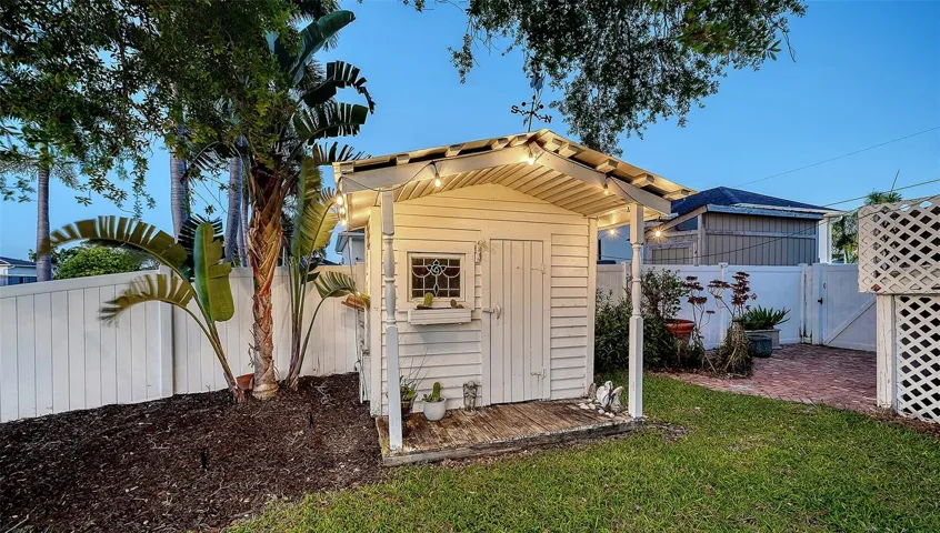 Quaint storage shed with private brick patio