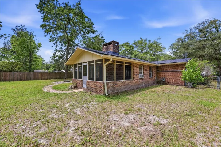Screened porch with backyard path to fire pit