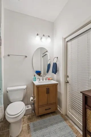 Full bathroom at the back of the home serves office bedroom and pool