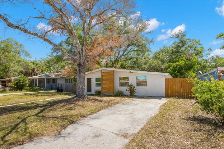 Extended driveway and gated side yard provide convenient parking and added privacy.