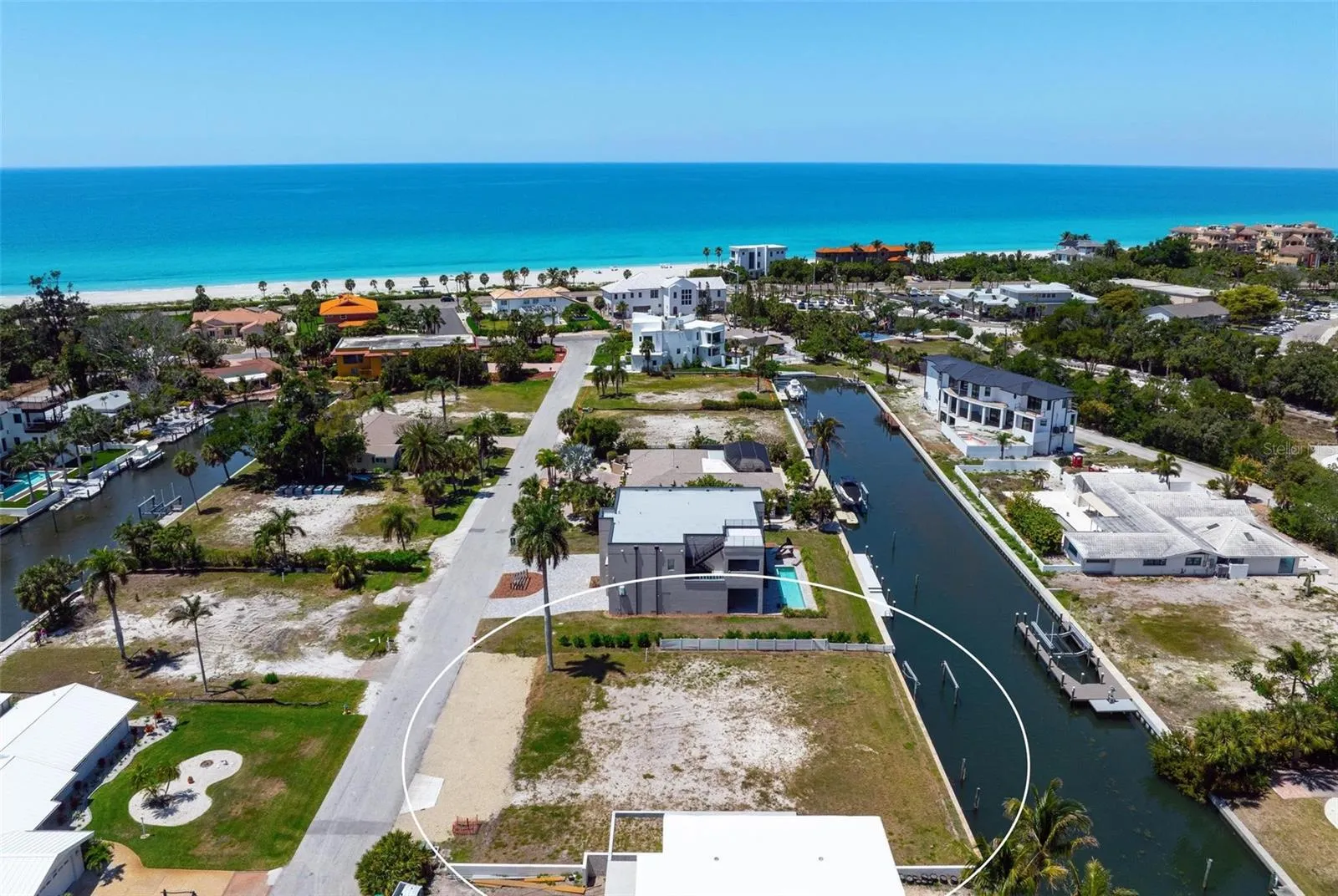 Drone view of vacant lot looking west