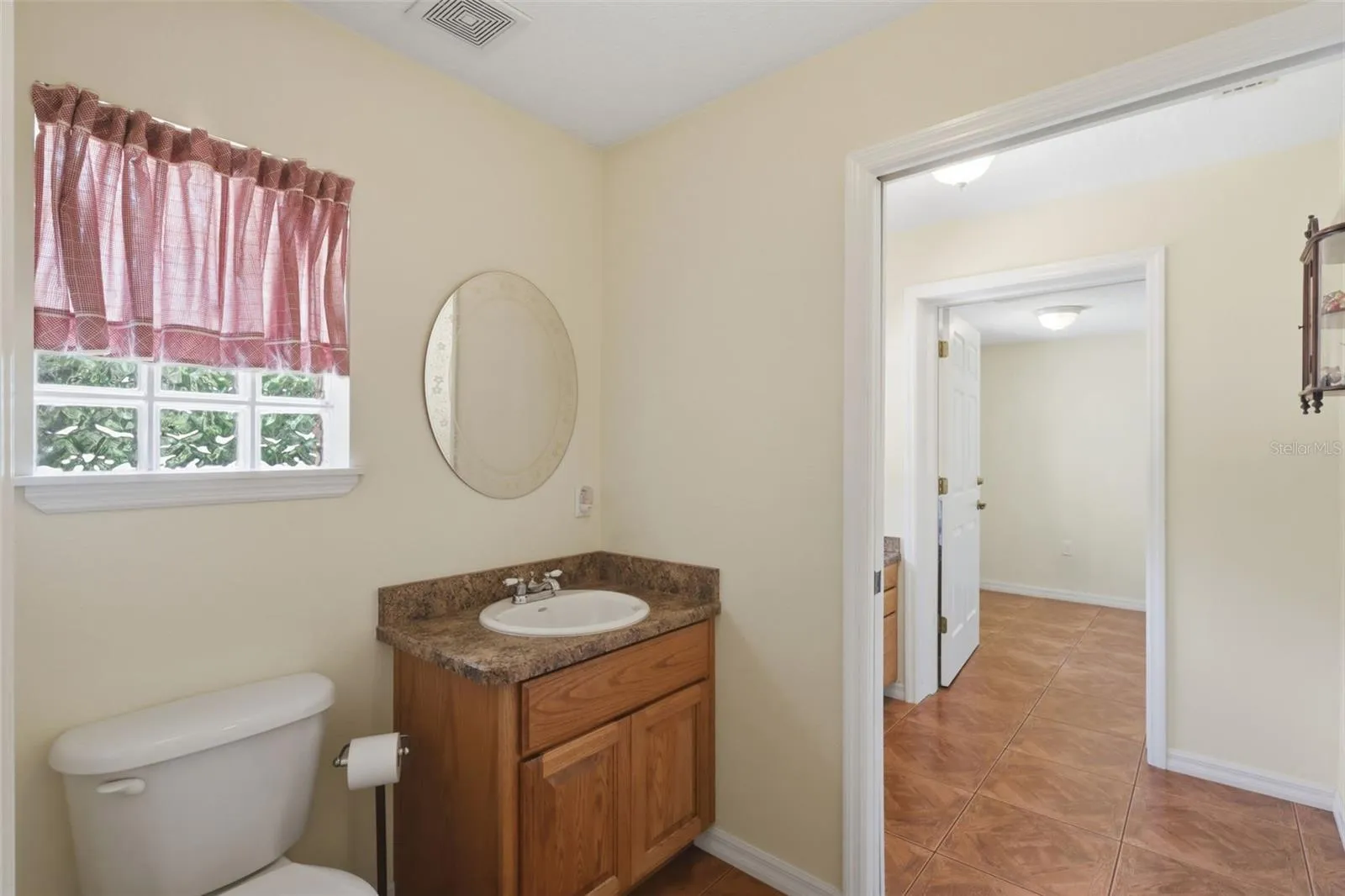 Half bath leading to office and safe room