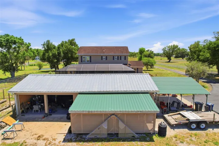 24 x 50 4 bay garage with workshop and additional covered storage area for equipment