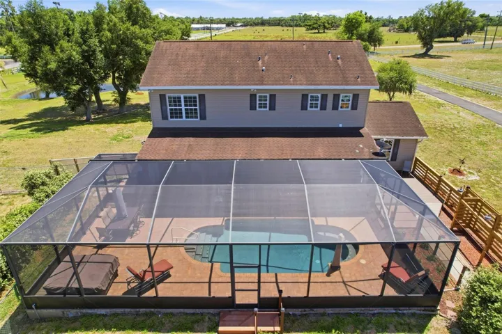 Outdoor living space with pool, offering room to relax and enjoy the surrounding acreage