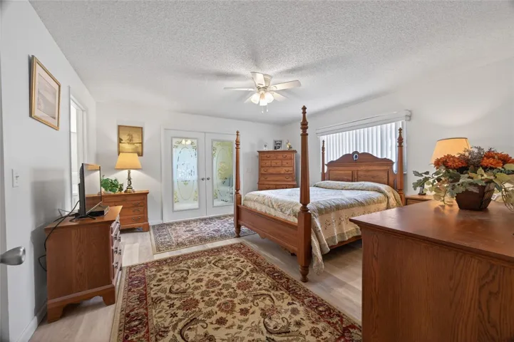 Primary bedroom with french doors that open to the second family room. Ensuite bathroom and large walk in closet and luxury vinyl planking.