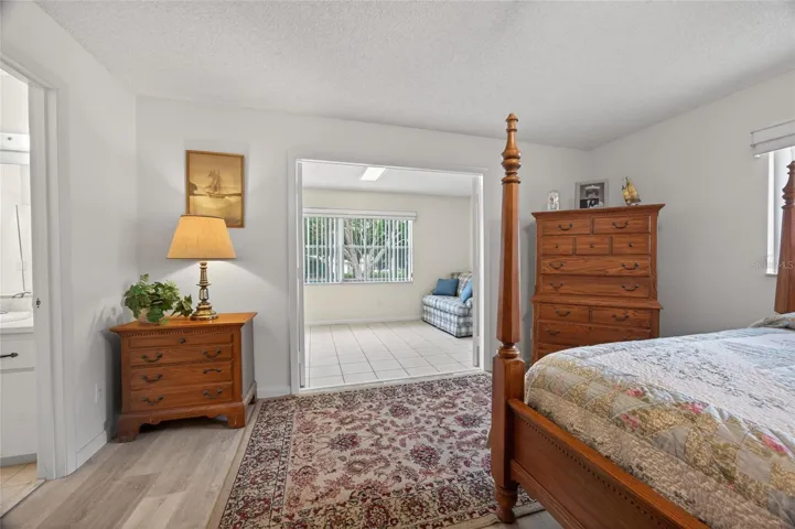 Entrance to second family room through french doors in the primary bedroom. The second family room has a door leading to the back patio and green space.