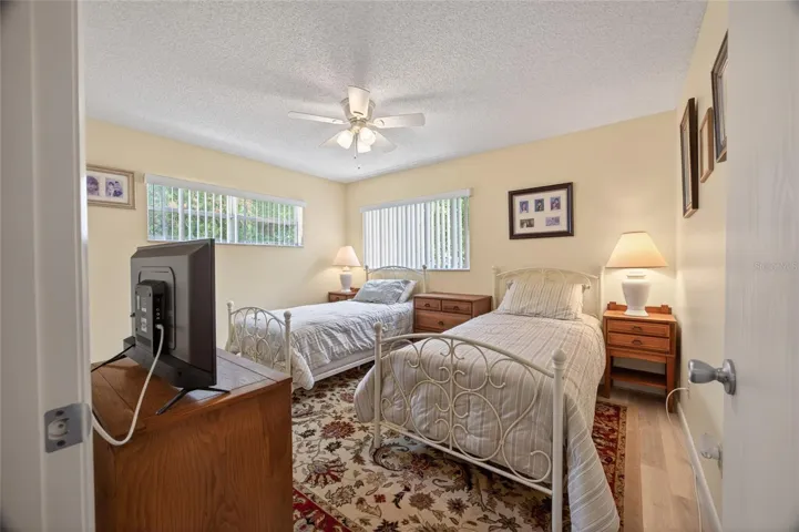 Secondary bedroom with big window, luxury vinyl planking and large closet.