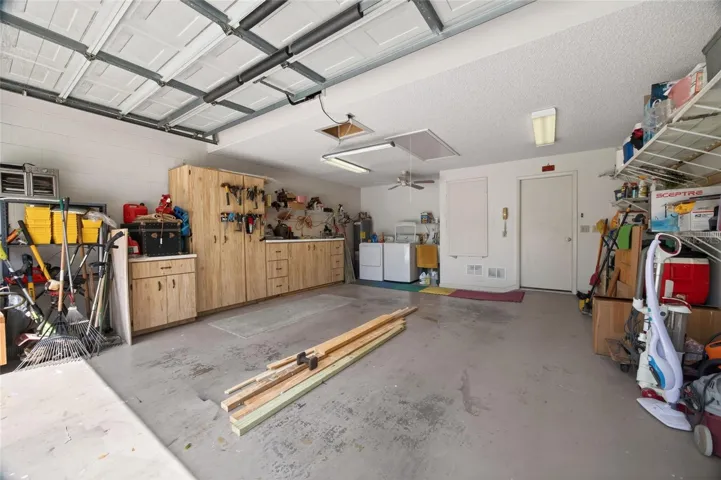 1.5 car garage has built in wood bench and storage area plus storage shelves. Washer and dryer.