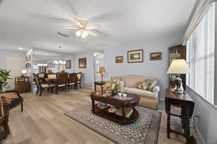 Light and bright living and dining room have luxury vinyl planking, large window and storage or coat closet.