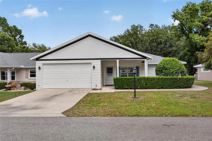 Front with 1.5 car garage and covered porch with room for chairs.