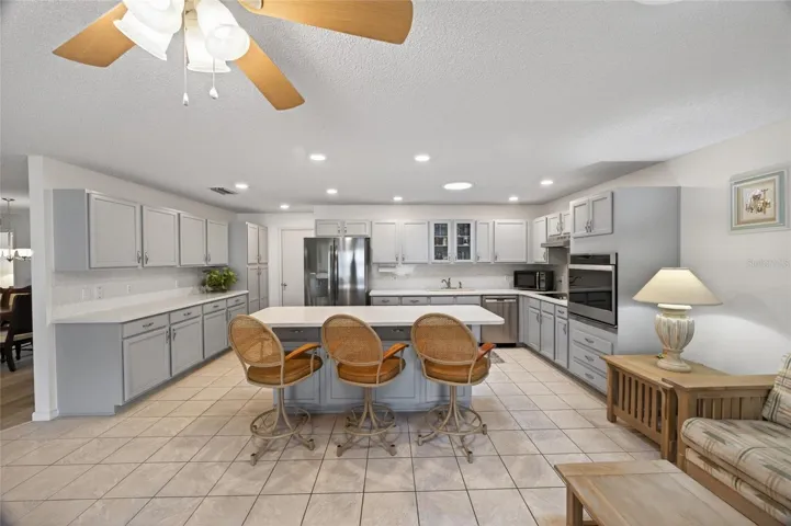 Lots of solid wood cabinets, stainless steel appliances, counterspace for and build in range.