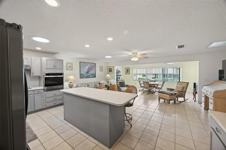 Kitchen opens to the first family room. The second family room is on the back side of the home. Lots of recessed lights and natural light form a second solar tube and large window.