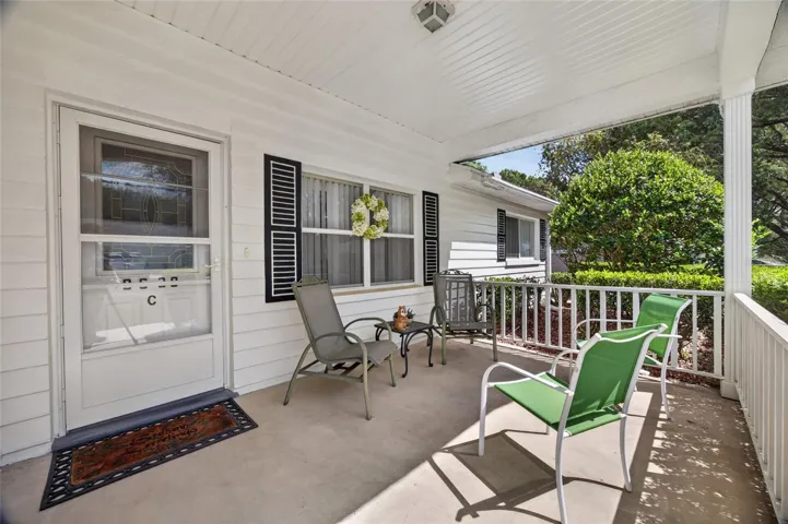 Covered front patio provides a gathering area or quiet place to read a book.