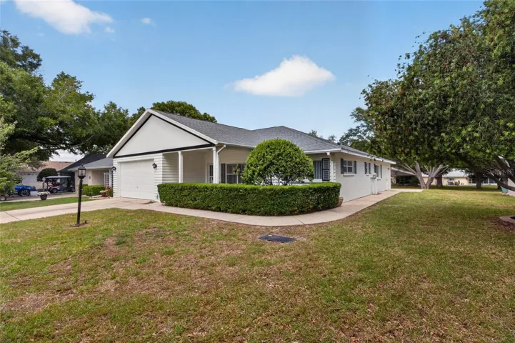 Large front and side yard with trees. Yard is maintained by the HOA.