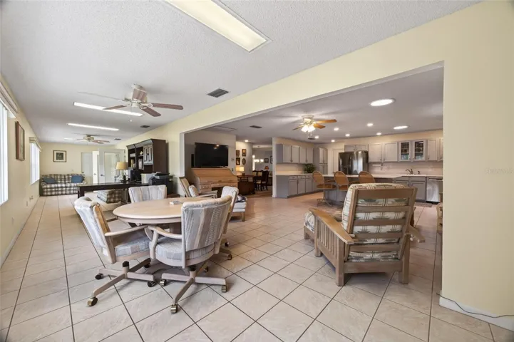 Second family room stretches the entire length the the home giving room for game tables, a home office or crafting and hobby area. Lots in in ceiling lights and 2 ceiling fans.