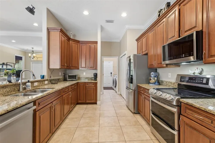 Notice the laundry room easily accessible to the kitchen and leading to the 3-car tandem garage.