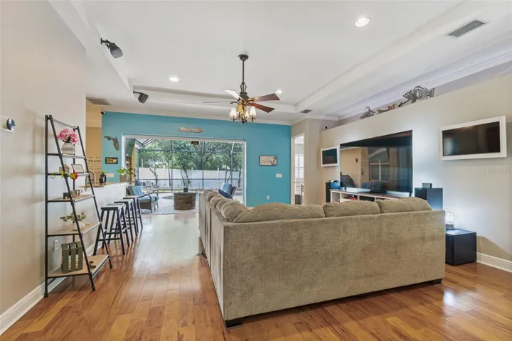 Check out the 3-slider door that is recessed all the way into the wall. Now your indoors becomes the outdoors. Screened lanai adds to the comfort! Outdoor kitchen is in close proximity to the kitchen!