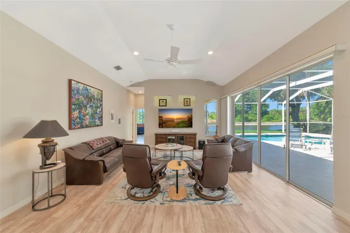 Family room open to kitchen with lanai pool & park views.
