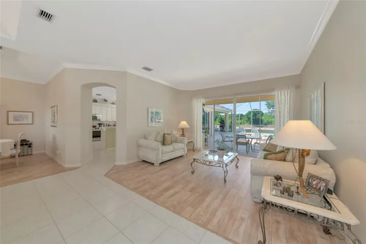 Combined living and dining room w/ crown molding.