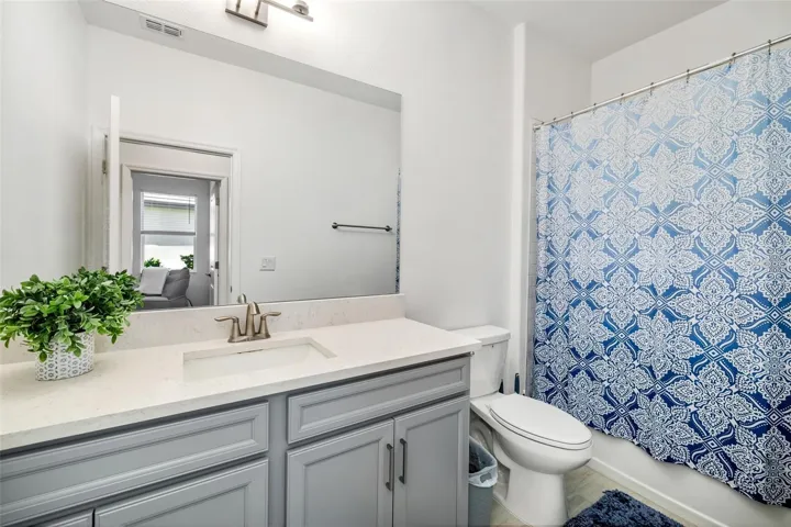 Full guest bathroom with modern vanity and clean finishes.