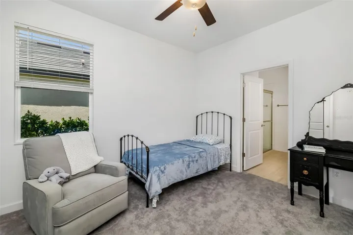 Comfortable guest bedroom with natural light and convenient access to full bath.