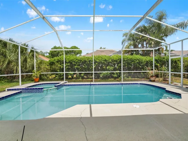 Private screened pool with tranquil water views and surrounding deck space, perfect for enjoying Florida’s year-round sunshine.