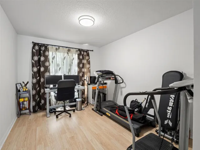 Versatile room ideal for a home office, gym, or hobby space, complete with natural light and functional layout.