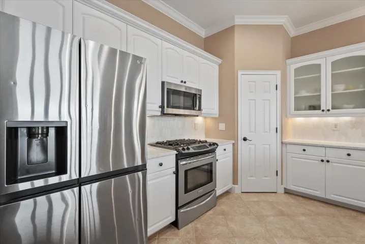 Kitchen with stainless steel appliances and closet pantry