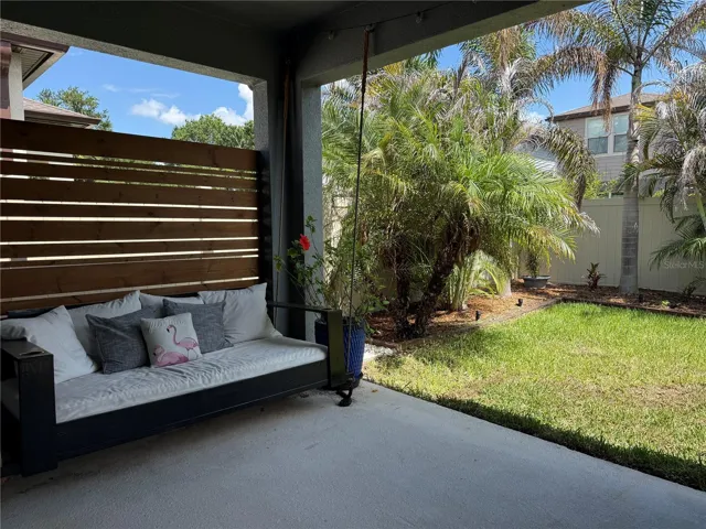 Covered lanai has a porch swing bed.
