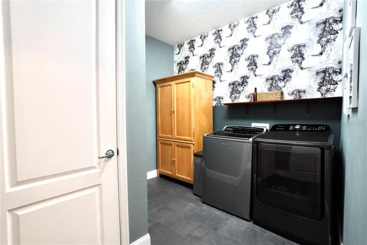 Laundry room with tile floor and closet for AC air handler.
