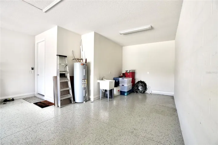 Oversized 2 car garage with epoxy floors, newer water heater and utility sink.