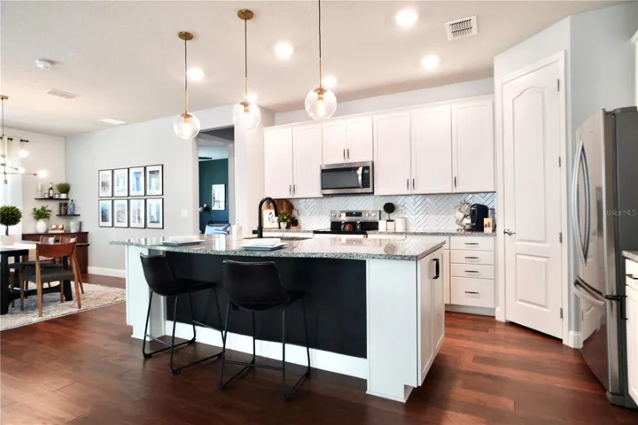 Pendant lighting above the island and an abundance of flush mount lighting.