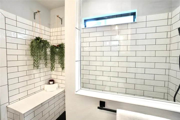 Built-in shower bench with frameless glass enclosure.