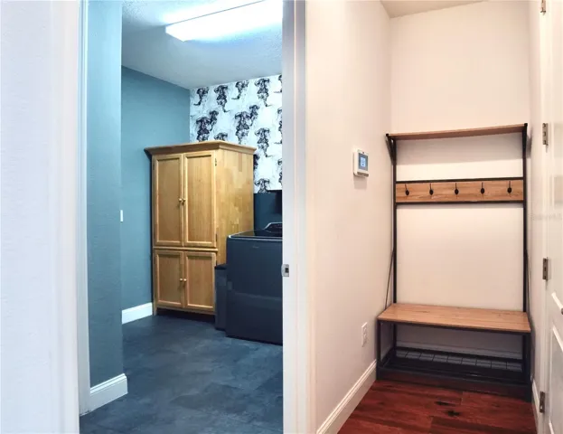 Laundry room and drop space located next to the door entering into the garage.