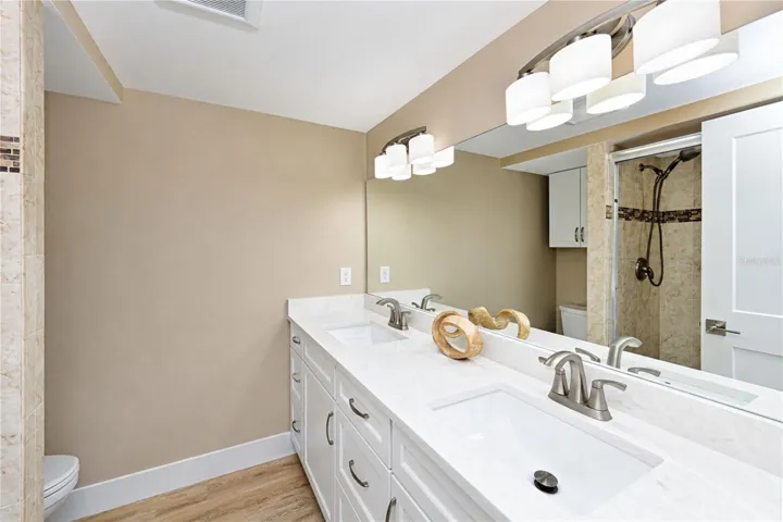 Primary bathroom with dual sink vanity and walk in shower